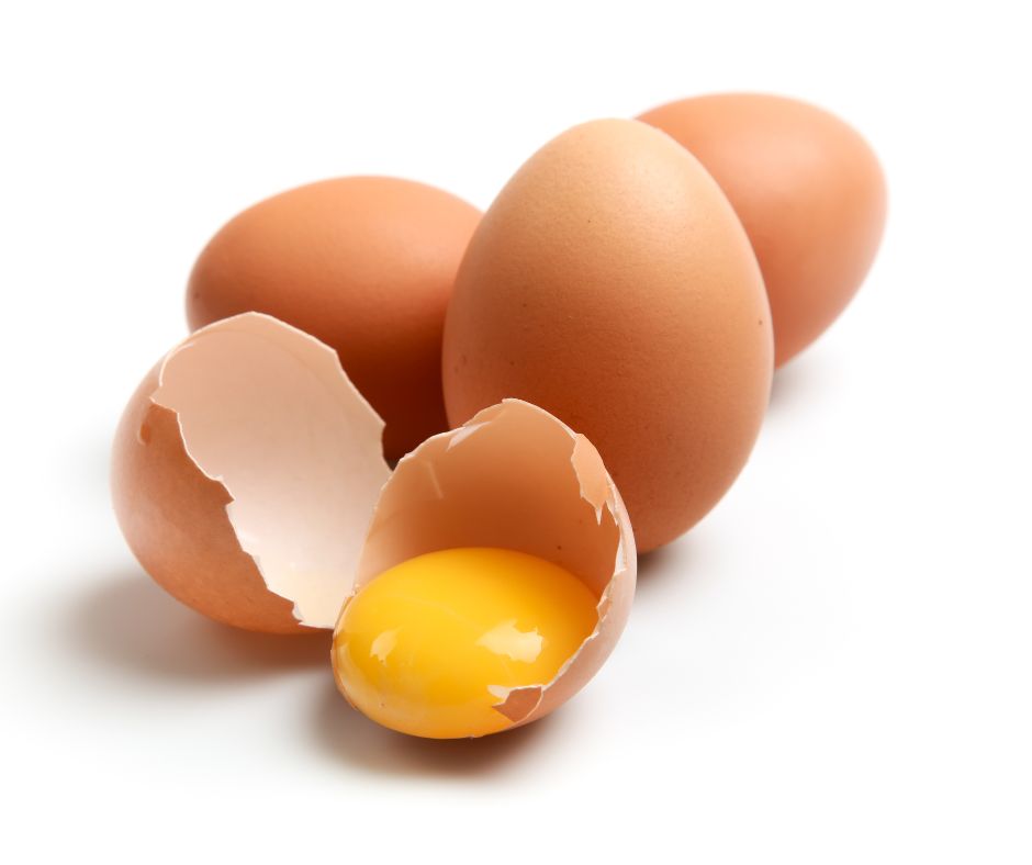 Eggs Next To Broken Egg With Yolk